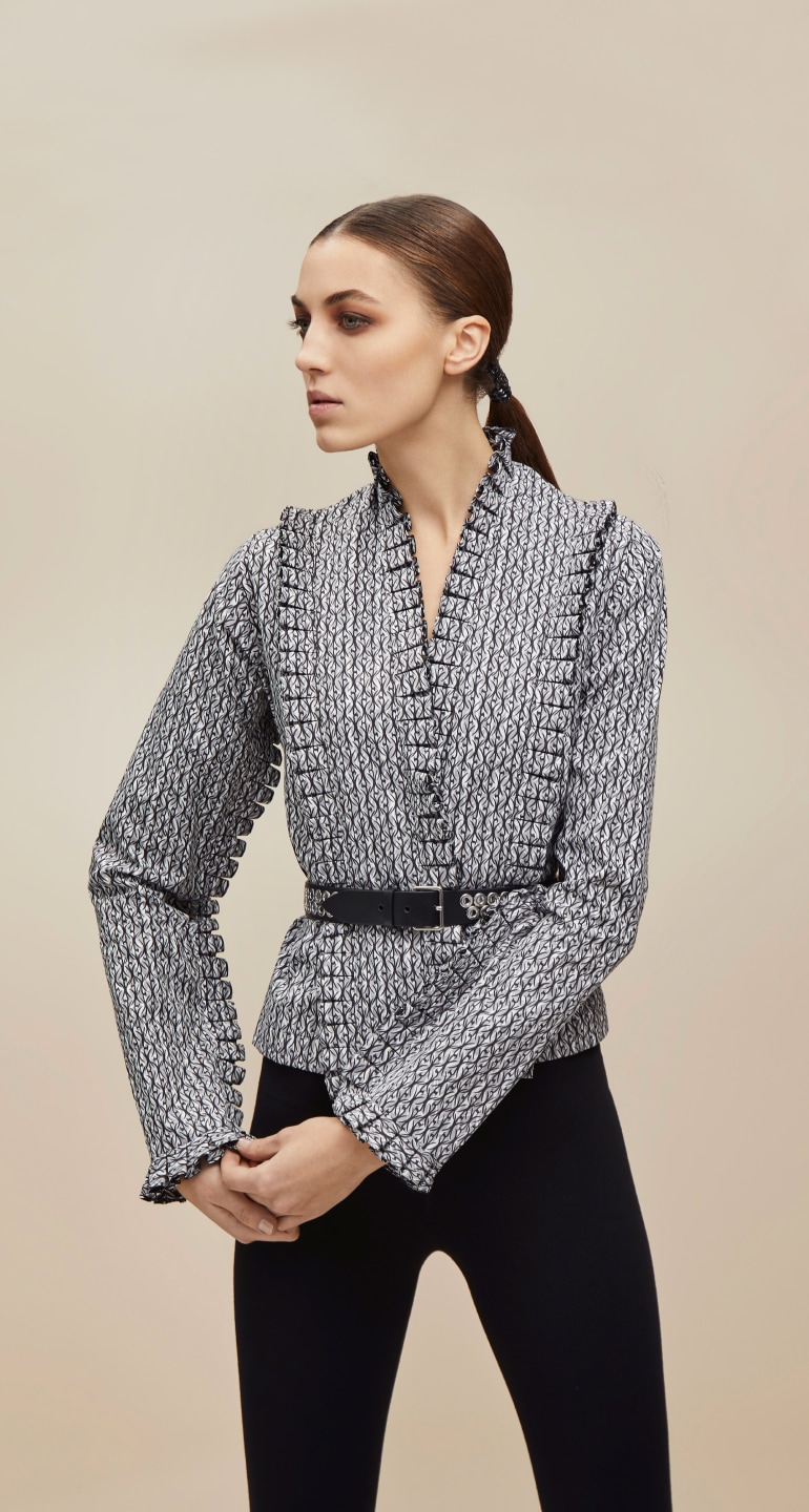 A woman standing with a stylish jacket